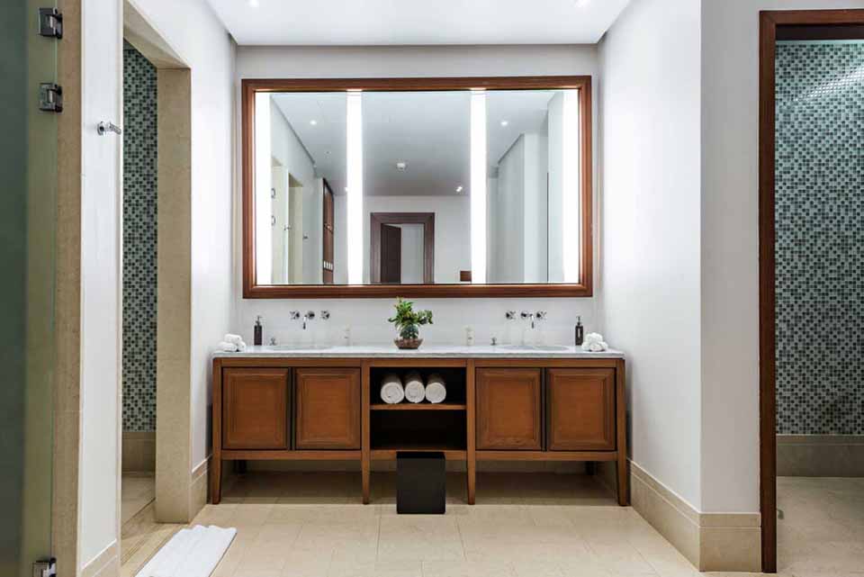 double vanity with stained wood cabinets