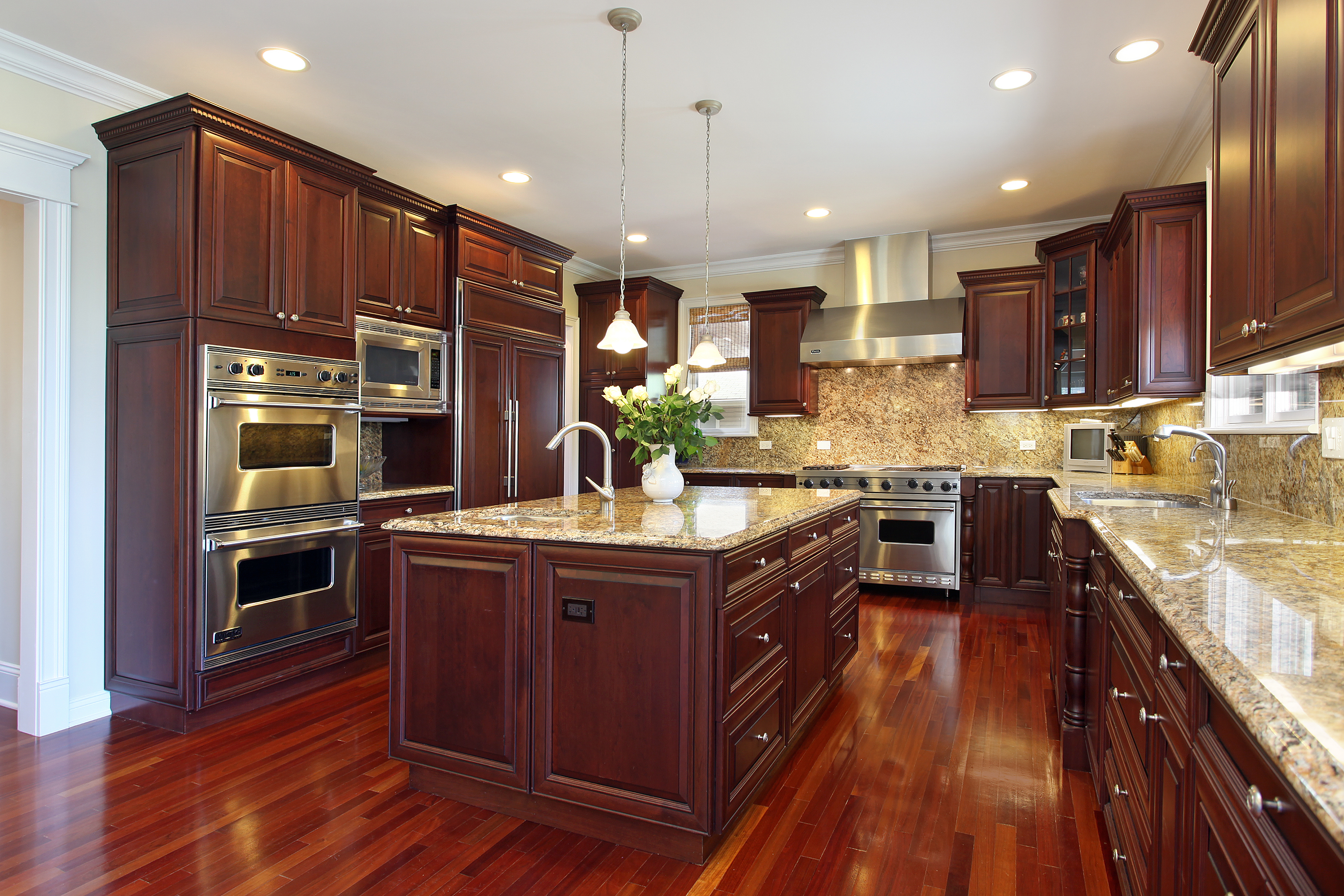 A large, traditional kitchen with dark stained cabinets.