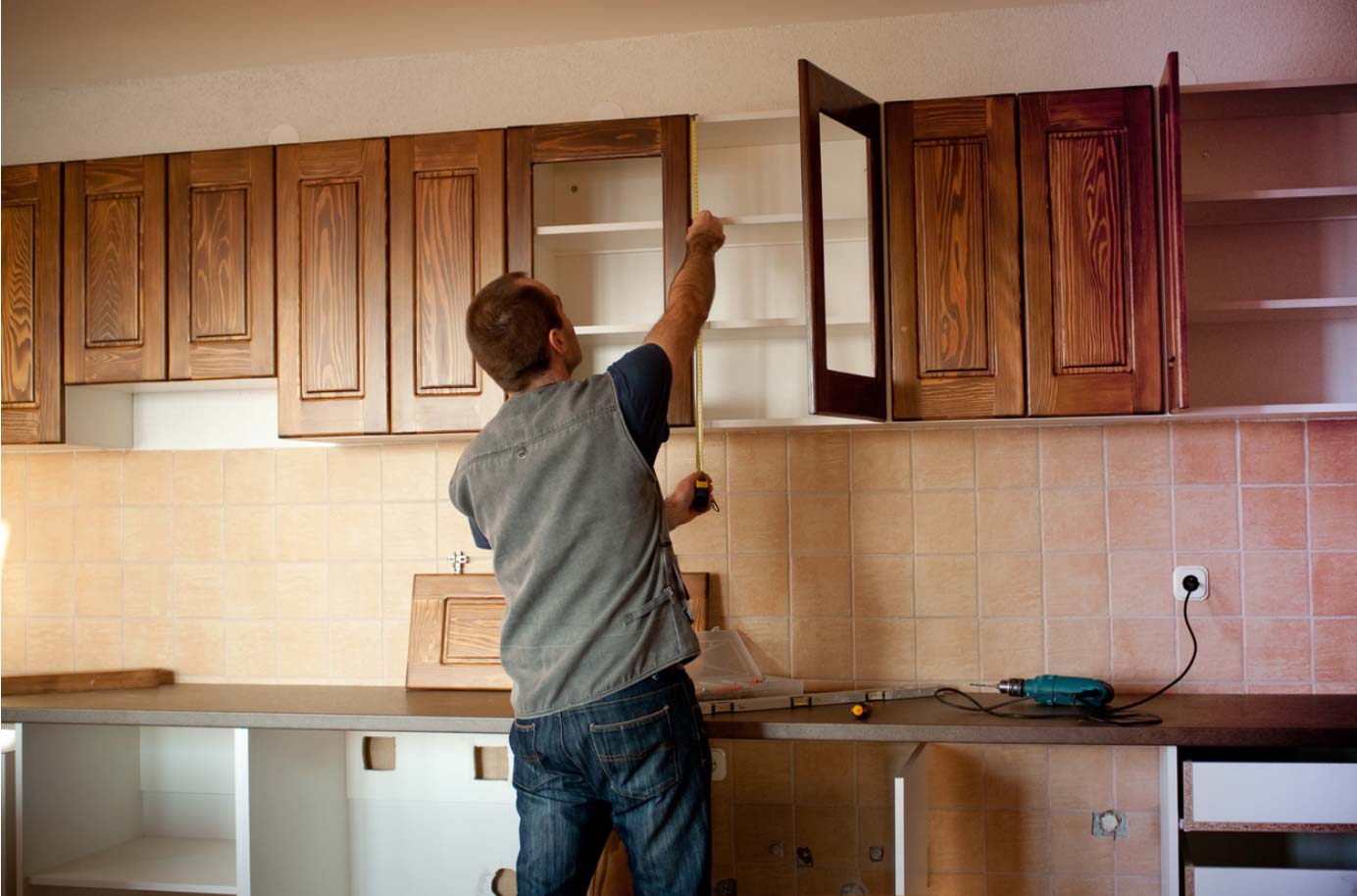 Man Measuring for Cabinets