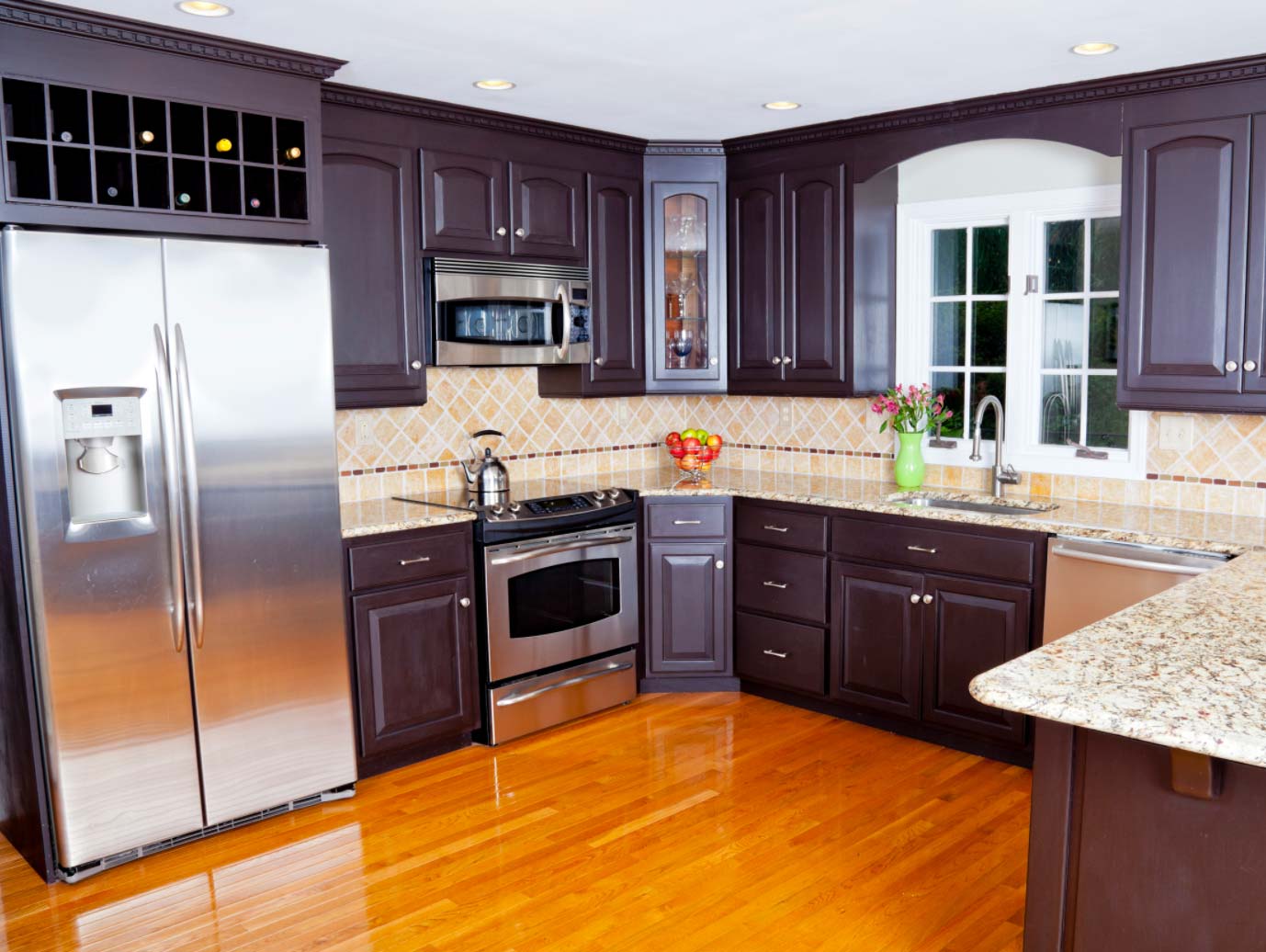 Modern domestic kitchen with new appliances and wooden floor