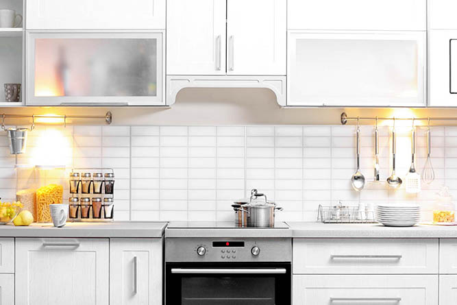 white kitchen with stainless steel oven 